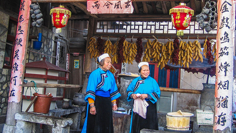 Two Buyi women wearing ethnic costumes